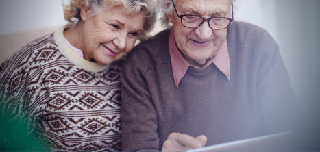 older couple smiling on laptop